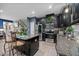 Modern kitchen with dark cabinetry, stainless steel appliances, and an island with bar seating at 409 Grand Palm Ln, Summerville, SC 29485