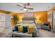 The bright and cheery main bedroom features a decorative ceiling fan and large picture windows at 409 Grand Palm Ln, Summerville, SC 29485