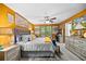 The bright and cheery main bedroom features a decorative ceiling fan and large picture windows at 409 Grand Palm Ln, Summerville, SC 29485