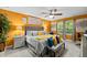 The bright and cheery main bedroom features a decorative ceiling fan and large picture windows at 409 Grand Palm Ln, Summerville, SC 29485