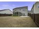 Spacious backyard featuring a screened porch and manicured lawn surrounded by a privacy fence at 484 Whispering Breeze Ln, Summerville, SC 29486