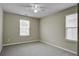 Bedroom featuring two windows, plush carpet, and neutral walls at 484 Whispering Breeze Ln, Summerville, SC 29486
