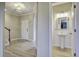 Inviting entryway showcasing staircase, entry door, and view of a half bathroom with pedestal sink at 484 Whispering Breeze Ln, Summerville, SC 29486
