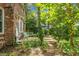 Landscaped backyard with a fountain and a patio seating area at 49 Crosscreek Dr, Charleston, SC 29412