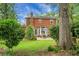 Expansive backyard with a patio area, ideal for outdoor dining and entertaining amid mature trees at 49 Crosscreek Dr, Charleston, SC 29412