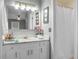 Bathroom with a large mirror, white cabinets, marble countertops, and a shower with a white curtain at 49 Crosscreek Dr, Charleston, SC 29412