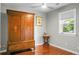 Bedroom with hardwood floors, a window with blinds, and antique wardrobe at 49 Crosscreek Dr, Charleston, SC 29412