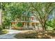 Charming two-story home featuring a wide front porch with white railings and a spacious driveway at 49 Crosscreek Dr, Charleston, SC 29412