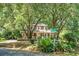 Charming two-story home with a white picket fence, mature landscaping, and a picturesque front yard at 49 Crosscreek Dr, Charleston, SC 29412