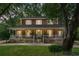 Charming two-story home featuring a wide front porch with white railings and brick accents at 49 Crosscreek Dr, Charleston, SC 29412