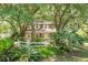 Charming two-story home with white trim, a lovely front porch, and lush, mature landscaping at 49 Crosscreek Dr, Charleston, SC 29412