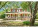 Charming two-story home featuring a wide front porch with white railings and brick accents at 49 Crosscreek Dr, Charleston, SC 29412