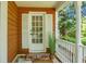 Charming front porch with a white door, matching shutters, and a brick landing at 49 Crosscreek Dr, Charleston, SC 29412
