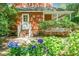Charming home with brick-accented front porch and lush landscaping, creating a welcoming entrance at 49 Crosscreek Dr, Charleston, SC 29412