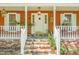 Charming home with brick-accented front porch, decorative lighting, and a welcoming white front door at 49 Crosscreek Dr, Charleston, SC 29412