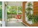 Cozy front porch with a charming red swing, perfect for relaxing and enjoying the outdoors at 49 Crosscreek Dr, Charleston, SC 29412