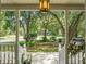 View from covered front porch, showcasing manicured lawn and landscaping at 49 Crosscreek Dr, Charleston, SC 29412