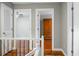 Second floor hallway with hardwood floors, and white trim at 49 Crosscreek Dr, Charleston, SC 29412