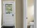 Hallway with a view to a half bath and an exterior door for easy access to the backyard at 49 Crosscreek Dr, Charleston, SC 29412