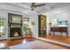 Charming living room with stone fireplace, hardwood floors, and decorative bookshelf at 49 Crosscreek Dr, Charleston, SC 29412