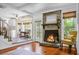 Inviting living room with stone fireplace, hardwood floors, and adjacent dining area at 49 Crosscreek Dr, Charleston, SC 29412