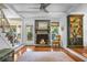 Cozy living room featuring a stone fireplace, hardwood floors, and a ceiling fan at 49 Crosscreek Dr, Charleston, SC 29412