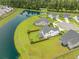 Aerial shot of a well-manicured home featuring backyard privacy fence and a large pond at 603 Cavour Ct, Summerville, SC 29486