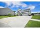 Inviting two-story home with a lush lawn, palm trees and a wide driveway at 603 Cavour Ct, Summerville, SC 29486