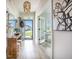 Bright hallway with an open doorway, stylish decor, views of the neighborhood, and a decorative chandelier at 603 Cavour Ct, Summerville, SC 29486