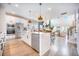 Open-concept kitchen with a large island, stainless steel appliances, and seamless flow to the living area at 603 Cavour Ct, Summerville, SC 29486