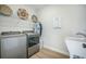 Well-equipped laundry room with stainless steel washer, dryer and utility sink at 603 Cavour Ct, Summerville, SC 29486