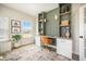 Bright home office with custom shelving, built in desk, a comfortable seating area, and large windows at 603 Cavour Ct, Summerville, SC 29486