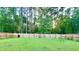 Private fenced backyard offers lush green space and a serene wooded backdrop, perfect for relaxation and recreation at 619 Red Mulberry Rd, Moncks Corner, SC 29461