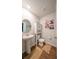 Compact bathroom with a pedestal sink, toilet, and decorative wall art adding a touch of style at 619 Red Mulberry Rd, Moncks Corner, SC 29461