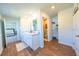 Bathroom featuring wood flooring, dual sinks, white cabinetry and a separate toilet area at 619 Red Mulberry Rd, Moncks Corner, SC 29461