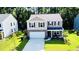 Charming two-story home features a brick and siding facade, attached garage, and a well-manicured front lawn at 619 Red Mulberry Rd, Moncks Corner, SC 29461