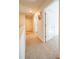 Bright hallway featuring neutral carpet, crisp white doors, and an inviting floral painting on the wall at 619 Red Mulberry Rd, Moncks Corner, SC 29461