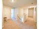 Upstairs hallway with neutral carpet and doors leading to bedrooms and bathrooms at 619 Red Mulberry Rd, Moncks Corner, SC 29461