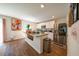 Modern kitchen with stainless steel appliances, white cabinets, an island, and hardwood floors at 619 Red Mulberry Rd, Moncks Corner, SC 29461