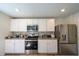 Well-lit kitchen with white cabinets, stainless steel appliances, and tiled backsplash at 619 Red Mulberry Rd, Moncks Corner, SC 29461