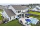 Aerial view showcasing backyard oasis with pool, lounge area, screened porch, and lush landscaping at 626 Chigwell Springs Ln, Summerville, SC 29486