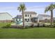 Expansive backyard with lush lawn, pool, patio with umbrella, screened porch, and tasteful landscaping at 626 Chigwell Springs Ln, Summerville, SC 29486