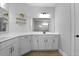 Bright bathroom featuring dual sinks, large mirrors, and tile flooring at 626 Chigwell Springs Ln, Summerville, SC 29486