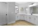 Spacious bathroom featuring dual sinks, large mirror, tile backsplash, and tile flooring at 626 Chigwell Springs Ln, Summerville, SC 29486