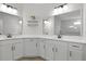 Bright bathroom with dual sinks, large mirror, and decorative accents at 626 Chigwell Springs Ln, Summerville, SC 29486