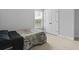 This is a cozy bedroom with neutral-colored walls, plush carpeting, and ample natural light from the window at 626 Chigwell Springs Ln, Summerville, SC 29486
