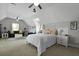 Large bedroom with a bed, ceiling fans, a dark sofa and other sitting area at 626 Chigwell Springs Ln, Summerville, SC 29486