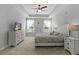 Spacious primary bedroom with tray ceiling, carpet, and large windows at 626 Chigwell Springs Ln, Summerville, SC 29486