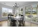 Cozy dining room with sliding glass doors to the patio, dark wood floors, and a modern chandelier at 626 Chigwell Springs Ln, Summerville, SC 29486