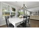 Inviting dining area features dark wood floors, a chandelier, and an outdoor view perfect for Gathering meals at 626 Chigwell Springs Ln, Summerville, SC 29486